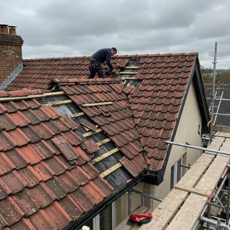 Dublin roofers carrying out roof repairs on a pitched slate roof